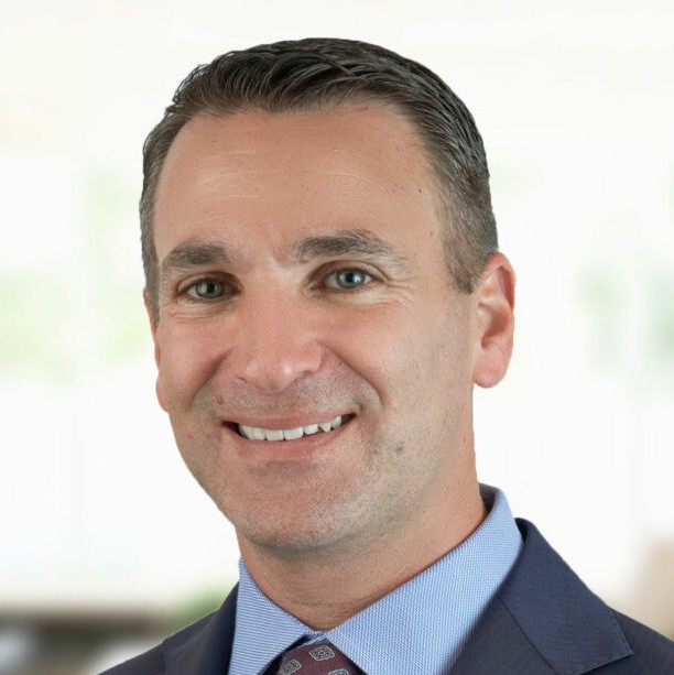 Smiling man in a suit with a blurred background. Smiling man in a suit with a blurred background.
